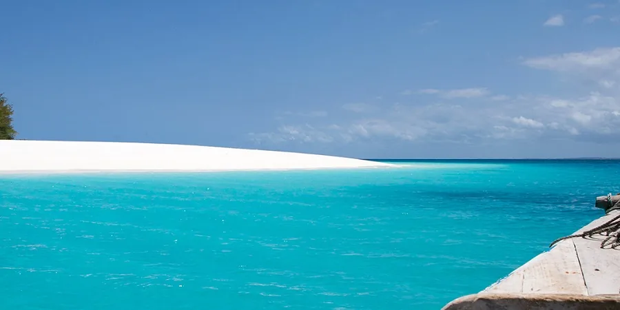 Turquoise water meeting a white sandbank off the coast of Zanzibar