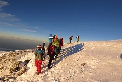 Kilimanjaro climbers trekking on rocky high-altitude terrain